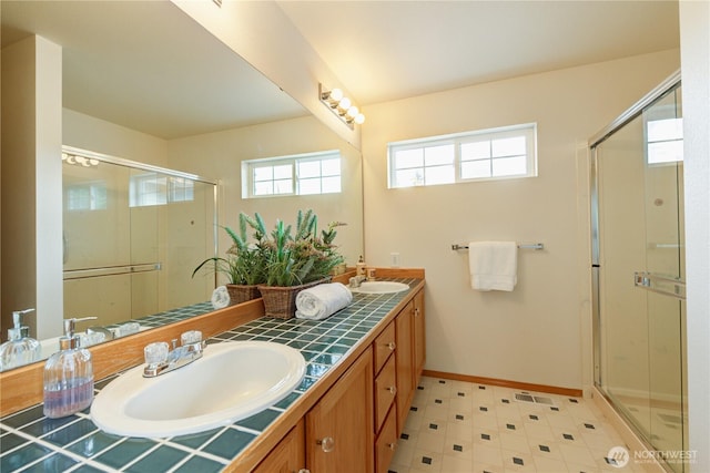 5511 152nd St SE, Everett, WA 98208 - full bathroom with double vanity, a stall shower, and baseboards