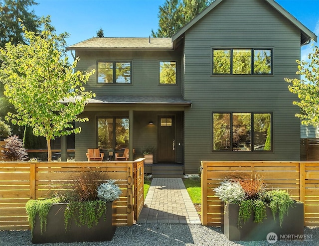 10419 41st Ave SW Unit A, Seattle, WA 98146 - view of front of house with a porch, fence, and roof with shingles