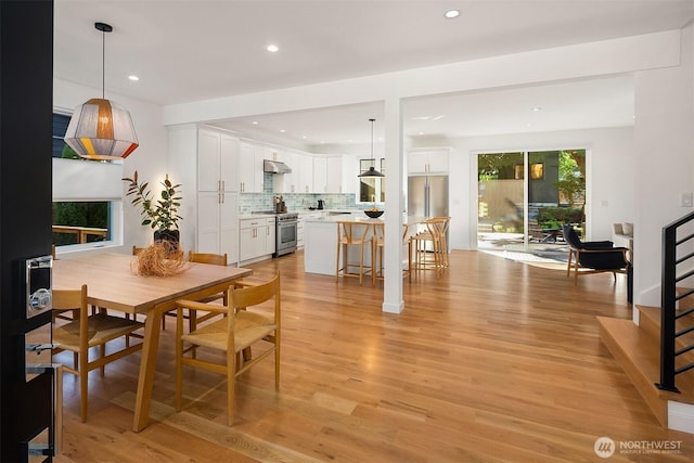 10419 41st Ave SW Unit A, Seattle, WA 98146 - dining room featuring light wood-type flooring, stairway, and recessed lighting