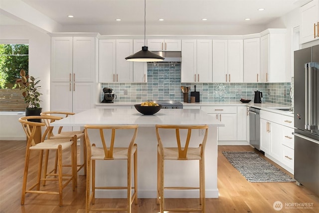 10419 41st Ave SW Unit A, Seattle, WA 98146 - kitchen featuring light countertops, white cabinetry, stainless steel appliances, and light wood-style flooring