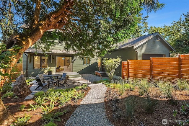 10419 41st Ave SW Unit A, Seattle, WA 98146 - back of property featuring fence, a garage, and a patio