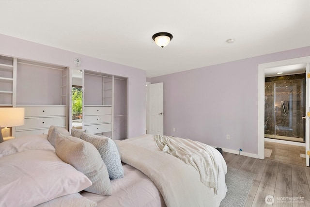 13832 146th Pl SE, Renton, WA 98059 - bedroom with wood finished floors, baseboards, and connected bathroom