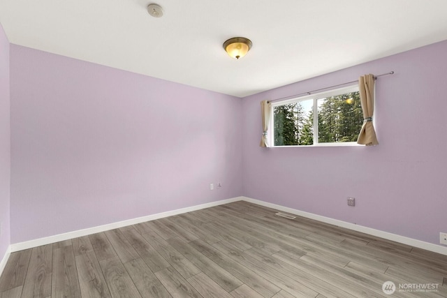 13832 146th Pl SE, Renton, WA 98059 - empty room with a smoke detector, wood finished floors, and baseboards