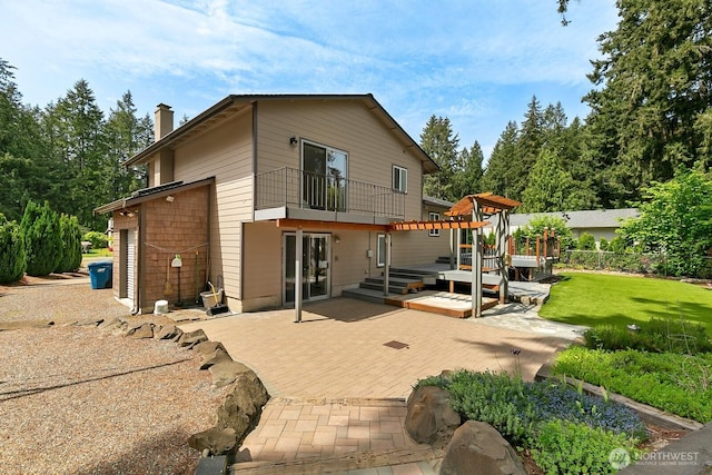 13832 146th Pl SE, Renton, WA 98059 - rear view of house featuring a balcony, a patio area, a chimney, and a deck