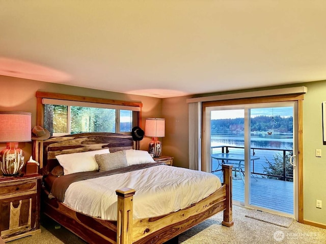 bedroom with access to outside and light colored carpet