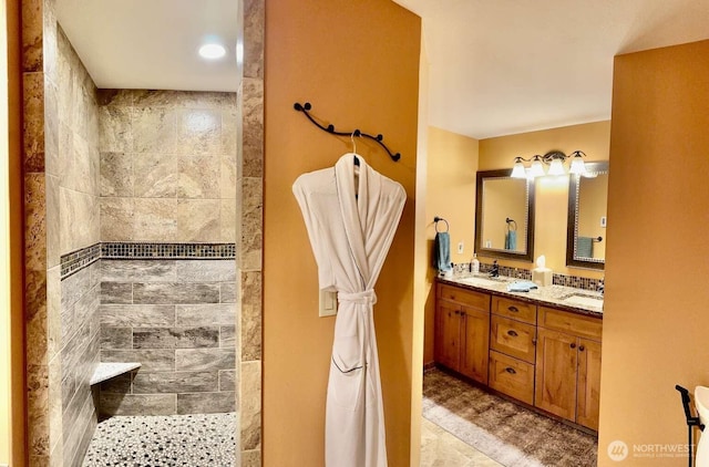 full bath with a walk in shower and double vanity