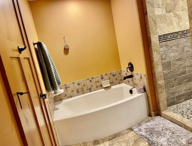 bathroom featuring a garden tub and a stall shower