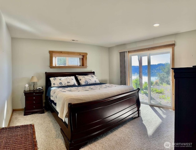 bedroom with access to exterior, light colored carpet, multiple windows, recessed lighting, and baseboards