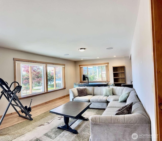 living area featuring wood finished floors, baseboards, and recessed lighting