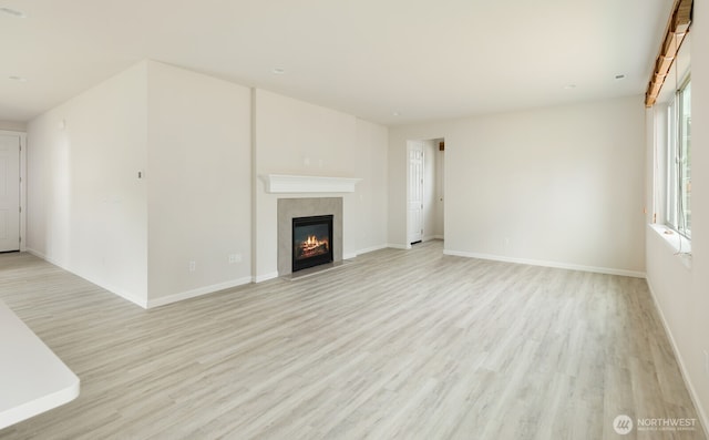 6146 Windlass Ave SE, Port Orchard, WA 98367 - unfurnished living room featuring light wood finished floors, a premium fireplace, and baseboards