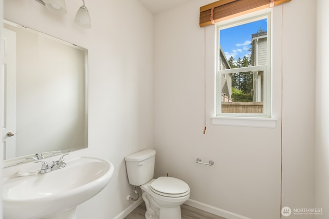 6146 Windlass Ave SE, Port Orchard, WA 98367 - bathroom featuring a sink, toilet, baseboards, and wood finished floors