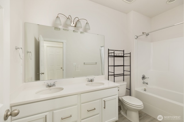 6146 Windlass Ave SE, Port Orchard, WA 98367 - bathroom with toilet, double vanity, shower / bath combo, and wood finished floors