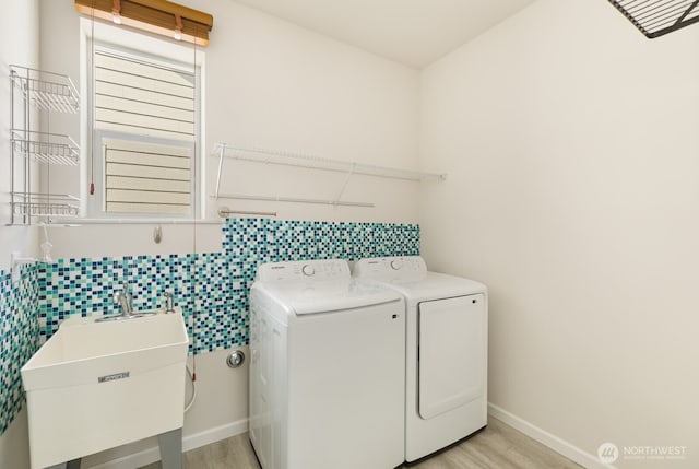 6146 Windlass Ave SE, Port Orchard, WA 98367 - laundry area featuring washer and dryer, light wood-type flooring, baseboards, and tile walls