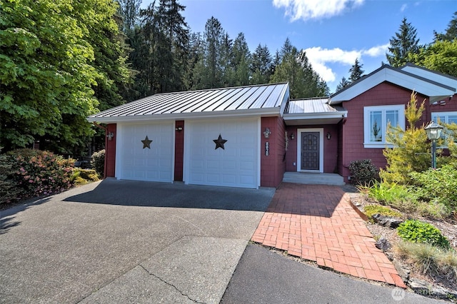 8820 E State Route 106, Union, WA 98592 - view of front of home featuring a standing seam roof, metal roof, and driveway