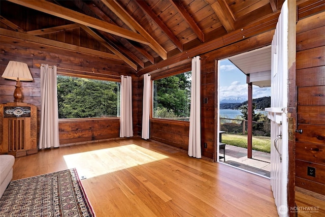 8820 E State Route 106, Union, WA 98592 - unfurnished living room with a water view, wood finished floors, wood walls, and wooden ceiling