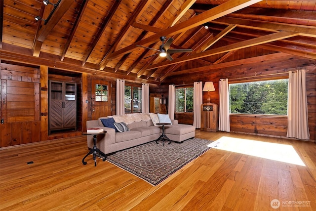 8820 E State Route 106, Union, WA 98592 - living room featuring wood walls, wood-type flooring, beam ceiling, healthy amount of natural light, and wooden ceiling