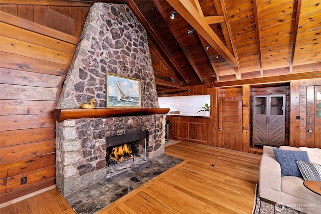 8820 E State Route 106, Union, WA 98592 - living room featuring wood walls, hardwood / wood-style floors, a stone fireplace, and wood ceiling
