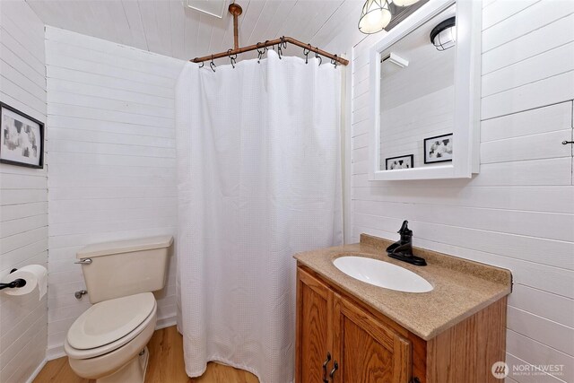 8820 E State Route 106, Union, WA 98592 - bathroom featuring toilet, wood finished floors, vanity, and curtained shower