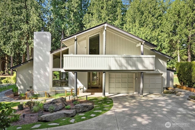 21010 NE 33rd Pl, Sammamish, WA 98074 - mid-century modern home featuring a balcony, driveway, a chimney, and a garage