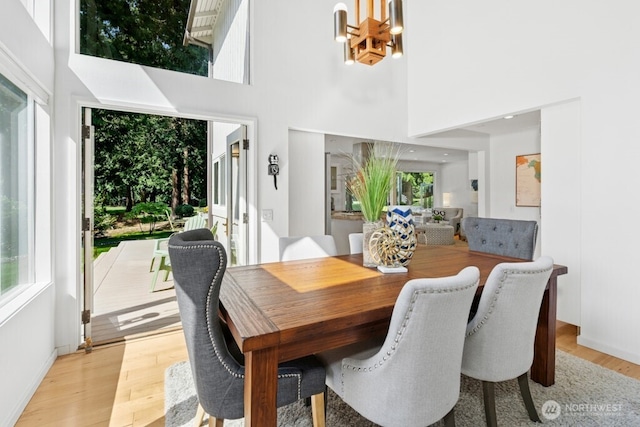 21010 NE 33rd Pl, Sammamish, WA 98074 - dining area with a chandelier, light wood-type flooring, and a high ceiling
