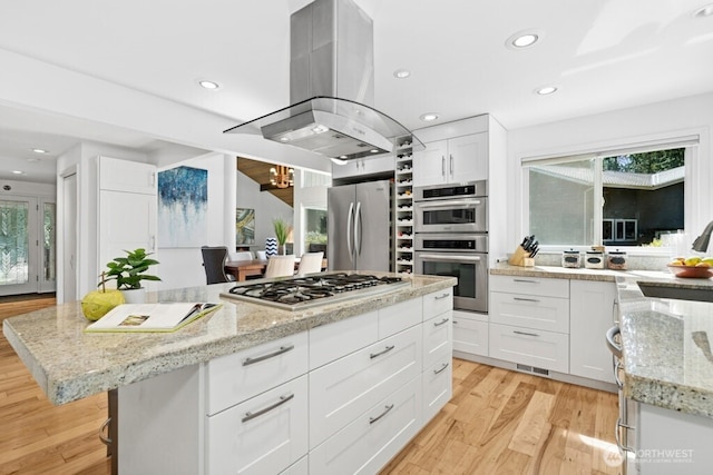 21010 NE 33rd Pl, Sammamish, WA 98074 - kitchen featuring stainless steel appliances, island exhaust hood, a sink, a kitchen island, and white cabinets