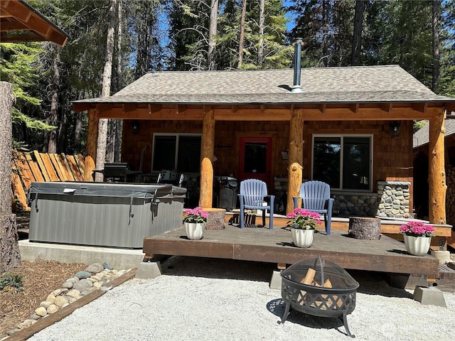 22415 Stirrup Rd, Leavenworth, WA 98826 - view of patio / terrace with a hot tub, an outdoor fire pit, and a wooden deck