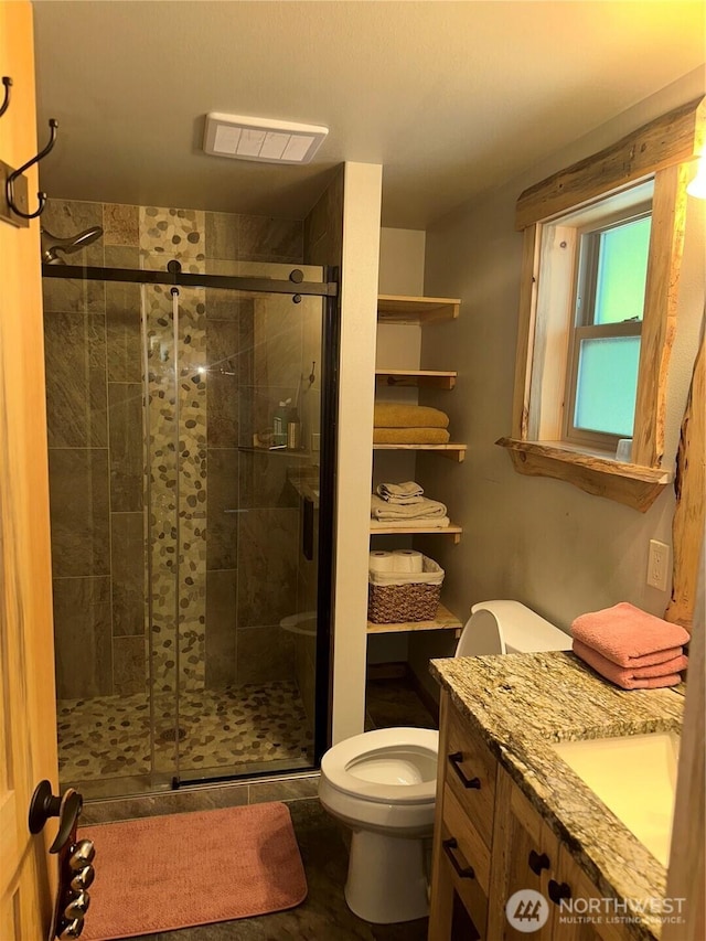 22415 Stirrup Rd, Leavenworth, WA 98826 - bathroom with toilet, a shower stall, and vanity