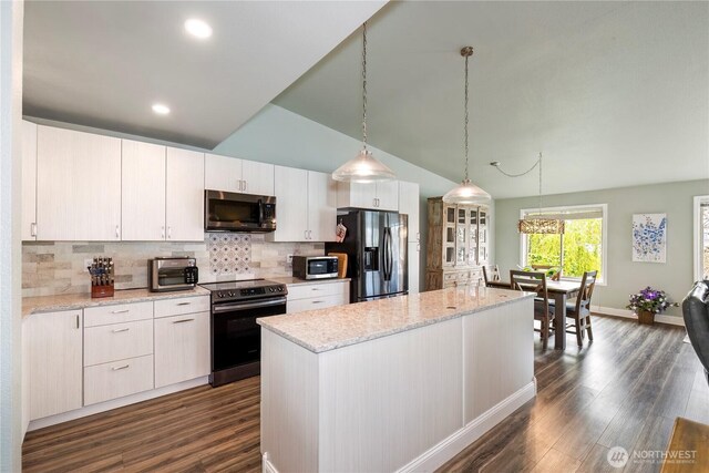 kitchen with appliances with stainless steel finishes, dark wood-style flooring, a kitchen island, decorative backsplash, and pendant lighting