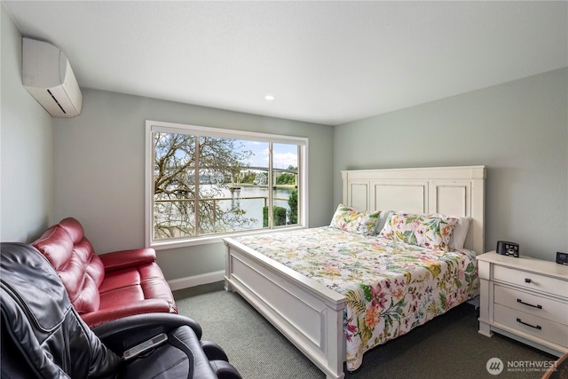 bedroom featuring a wall mounted AC, dark colored carpet, baseboards, and recessed lighting