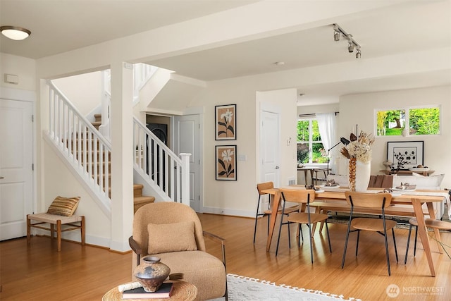 1748 25th Walk NE, Issaquah, WA 98029 - dining area featuring stairway, light wood-style flooring, rail lighting, and baseboards