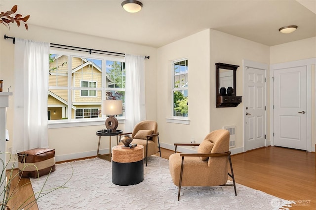 1748 25th Walk NE, Issaquah, WA 98029 - living area with wood finished floors, heating unit, and baseboards