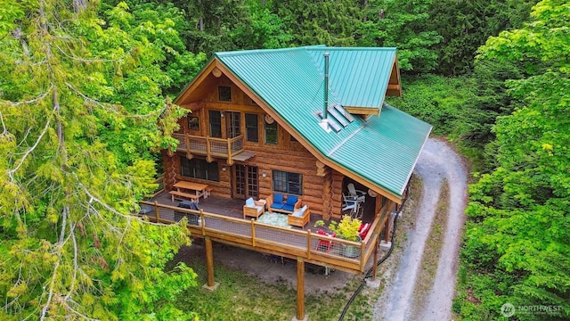 1465 Magnolia Ln, Camano Island, WA 98282 - rear view of house featuring log siding, outdoor lounge area, dirt driveway, a wooden deck, and a wooded view