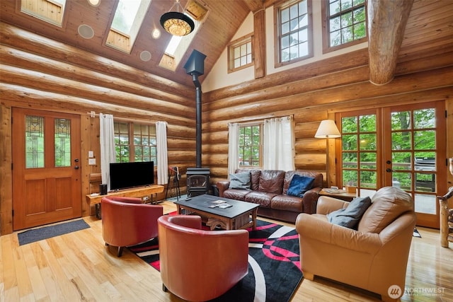 1465 Magnolia Ln, Camano Island, WA 98282 - living area with high vaulted ceiling, a wood stove, wooden ceiling, light wood-style flooring, and french doors