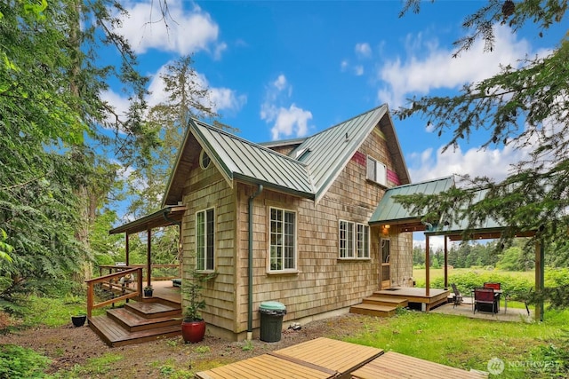 1465 Magnolia Ln, Camano Island, WA 98282 - back of house with a standing seam roof, metal roof, and a deck