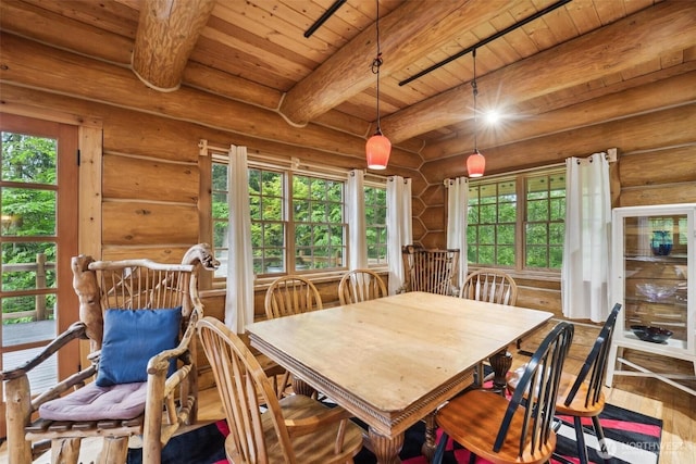 1465 Magnolia Ln, Camano Island, WA 98282 - dining space with wooden ceiling with exposed beams, wood finished floors, and rustic walls