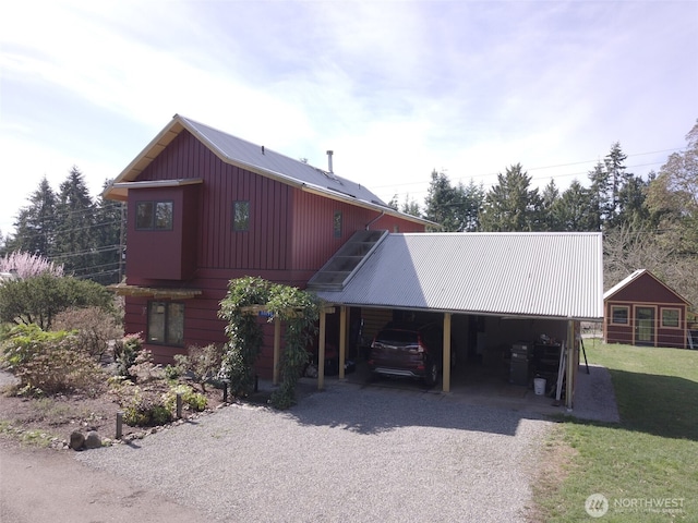 11191 Valley Heights Cir NE, Bainbridge Island, WA 98110 - view of front of property with gravel driveway, metal roof, a front lawn, and an attached carport