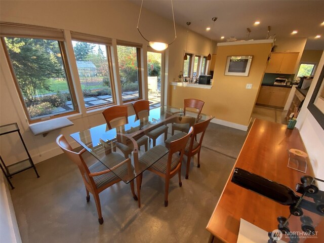 11191 Valley Heights Cir NE, Bainbridge Island, WA 98110 - dining area with baseboards, concrete floors, and recessed lighting