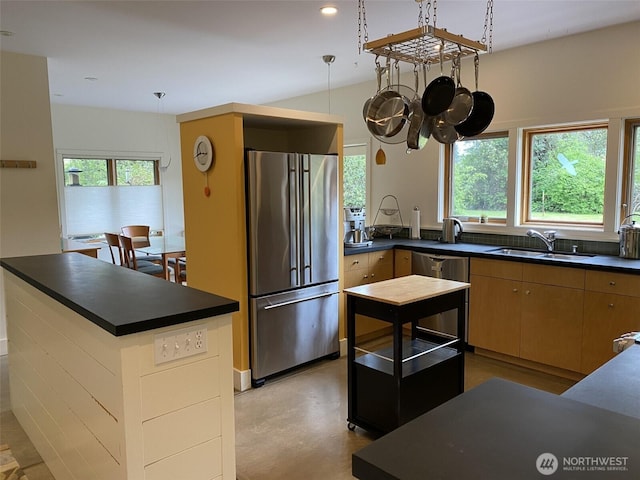 11191 Valley Heights Cir NE, Bainbridge Island, WA 98110 - kitchen with stainless steel appliances, a sink, dark countertops, a chandelier, and concrete floors