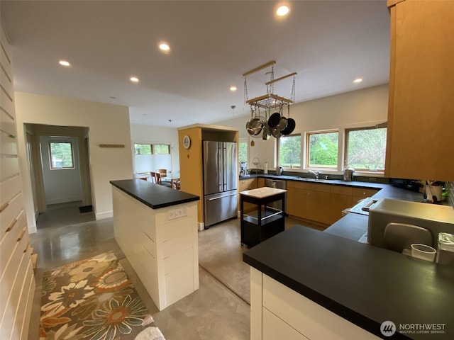 11191 Valley Heights Cir NE, Bainbridge Island, WA 98110 - kitchen with high end fridge, a sink, finished concrete flooring, dark countertops, and recessed lighting