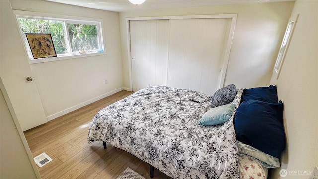 3333 228th St SE Unit 119, Bothell, WA 98021 - bedroom featuring light wood-style floors, a closet, and baseboards