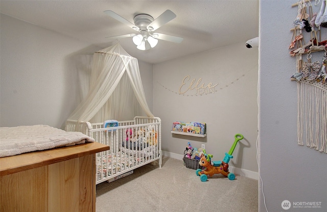 carpeted bedroom featuring a ceiling fan and baseboards