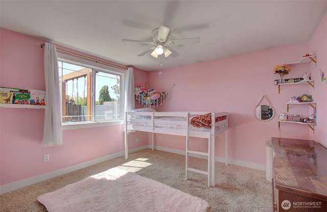 carpeted bedroom featuring baseboards and ceiling fan