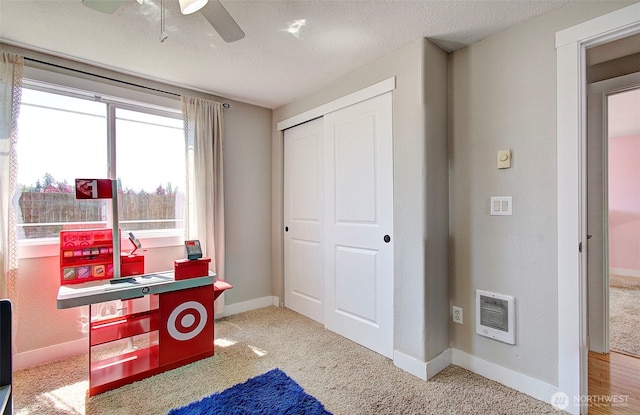 home office with carpet floors, ceiling fan, baseboards, and a textured ceiling