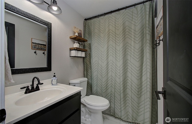 full bath featuring toilet and vanity