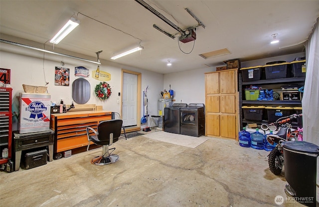 garage with a garage door opener, washing machine and dryer, and electric water heater