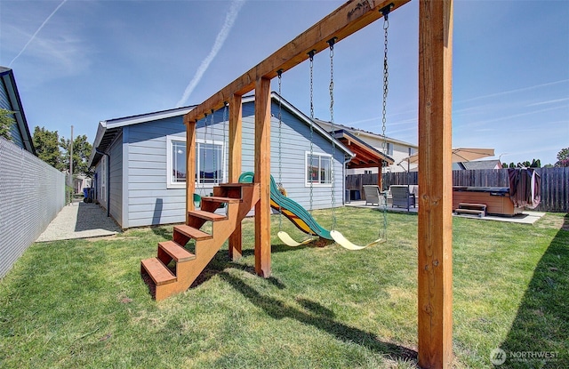 view of jungle gym featuring a hot tub