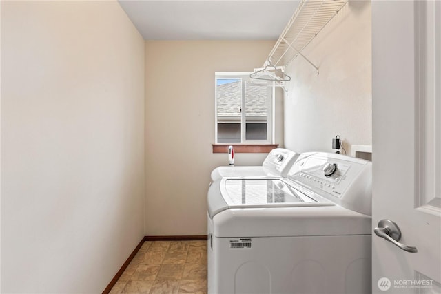 laundry area with washer and dryer and baseboards