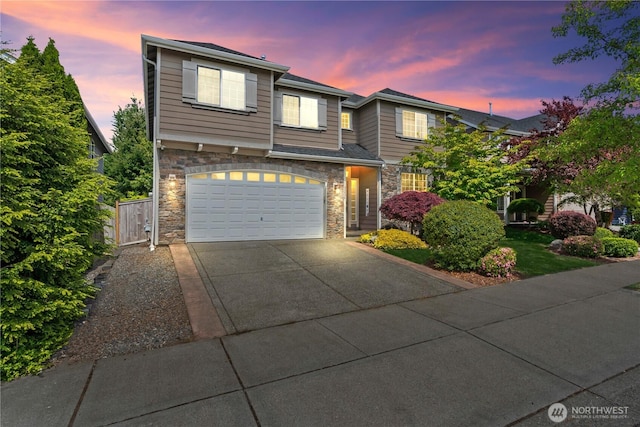 view of front of house with stone siding, concrete driveway, and a garage