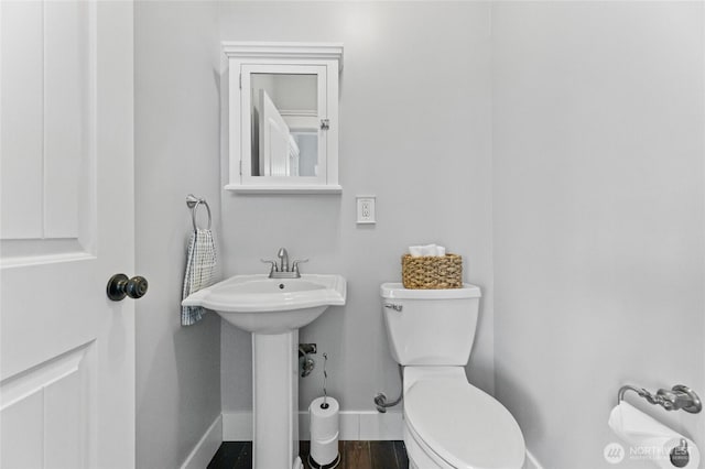 256 S C St, Buckley, WA 98321 - bathroom with baseboards, toilet, and a sink