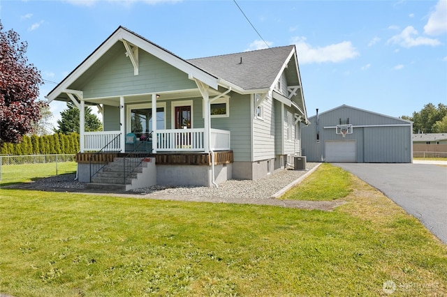 256 S C St, Buckley, WA 98321 - bungalow-style house with an outbuilding, central AC, covered porch, a detached garage, and roof with shingles